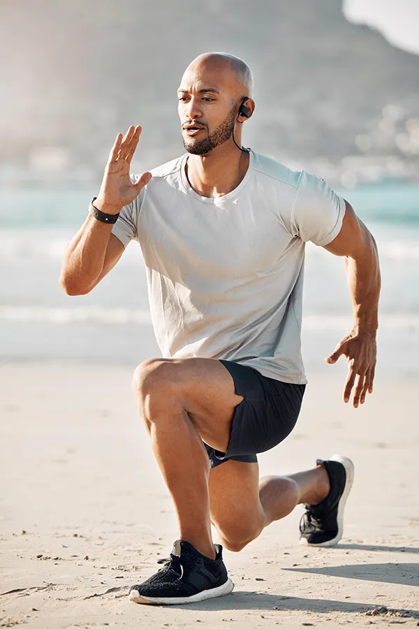 A man does lunges on the beach. Get treatment for MCL tears from ProCare Wellness Institute in Virginia Beach.