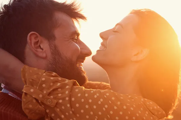 A happy couple embrace in the sunset. Get pain management services from ProCare Wellness Institute in Virginia Beach.