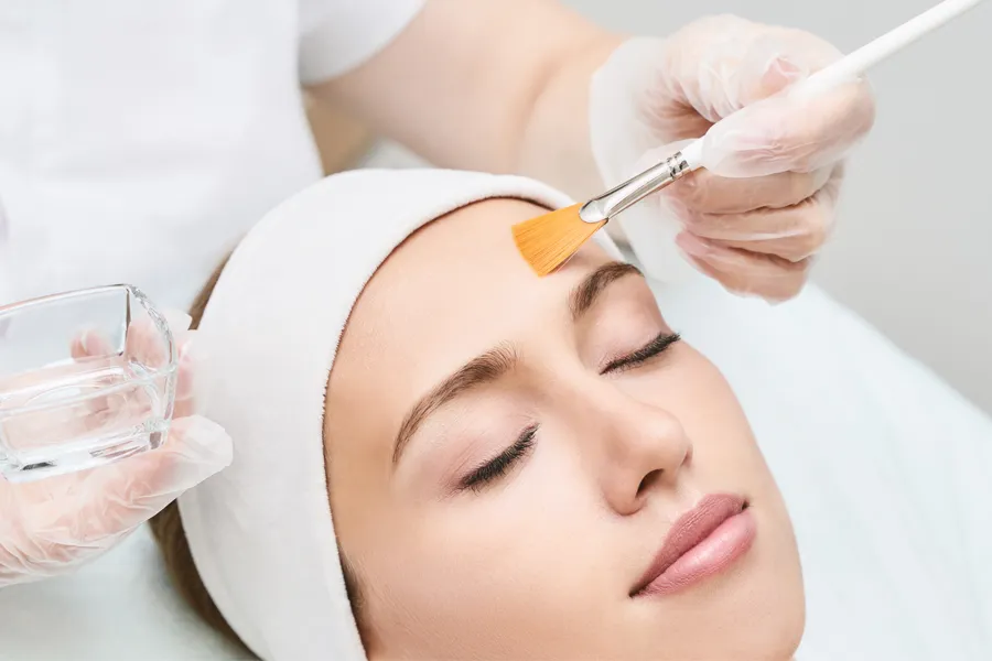 A woman receives a facial chemical peel treatment. Schedule Perfect™ Derma Peel Treatment from ProCare Wellness Institute in Virginia Beach.