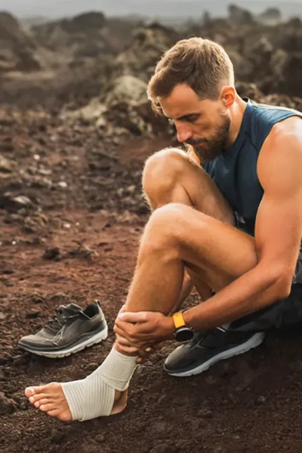 A man holds his ankle and foot in pain. Get plantar fasciitis treatment from ProCare Wellness Institute in Virginia Beach.