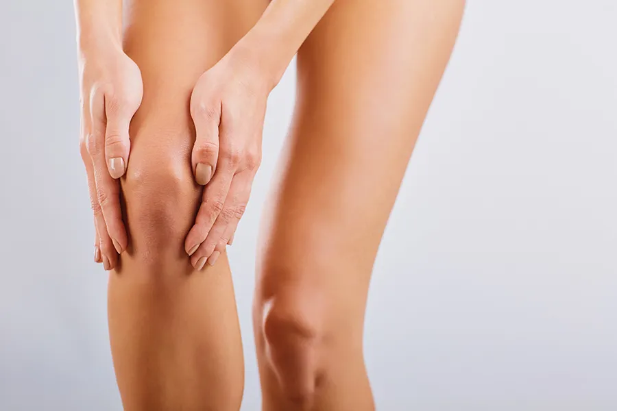 A woman displays her knees. Schedule Radiofrequency Microneedling for Knee Skin Treatment from ProCare Wellness Institute in Virginia Beach.