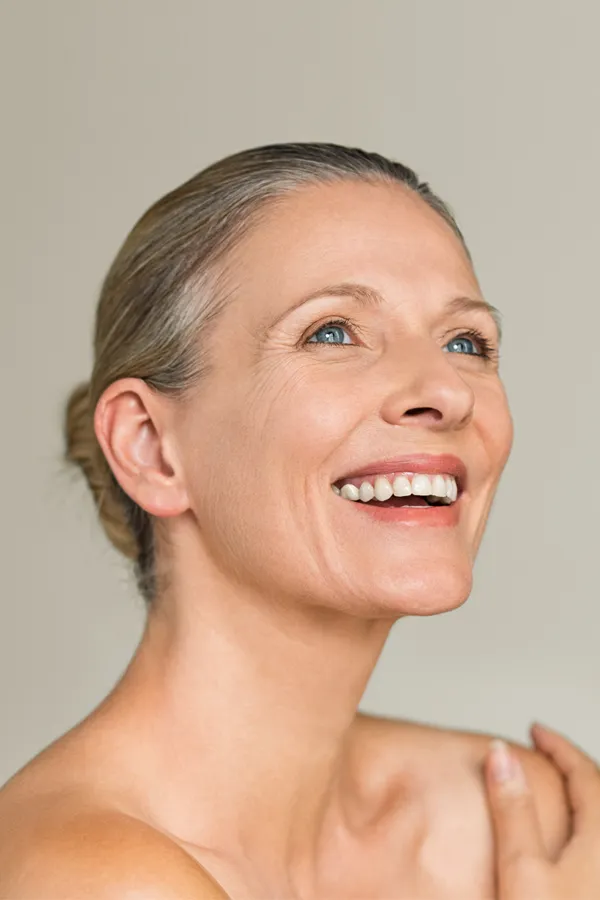 A middle-aged woman with a smooth, trim neck. Get Radiofrequency Microneedling for Neck Skin Treatment from ProCare Wellness Institute in Virginia Beach.