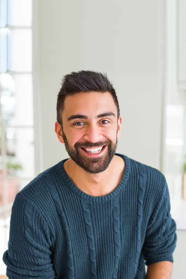A smiling man with good hair. Get Red Light Therapy for Hair Restoration from ProCare Wellness Institute in Virginia Beach.