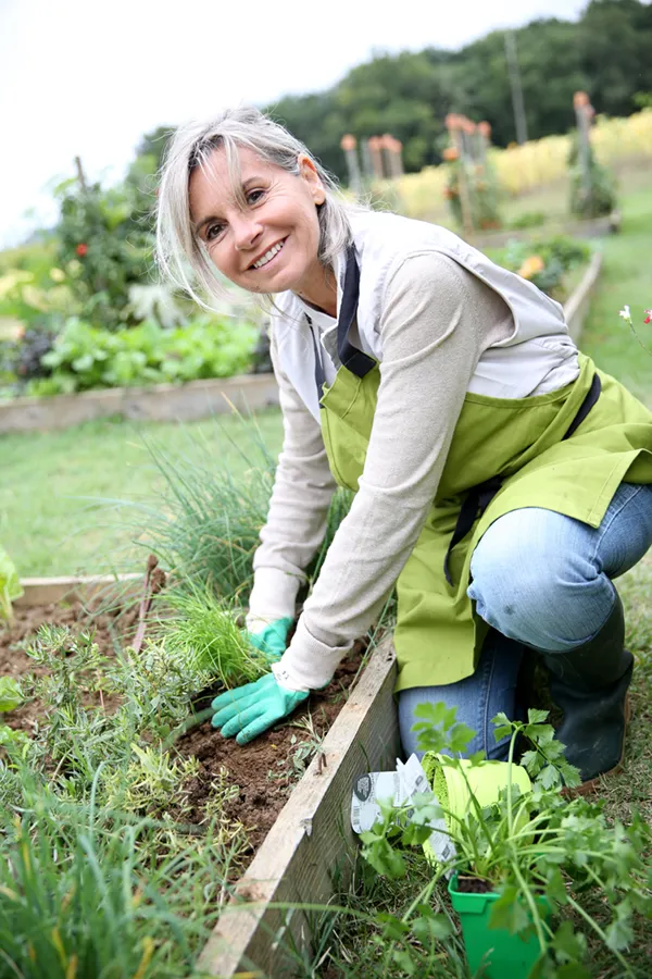 A woman gardens happily. Get rheumatoid arthritis treatment from ProCare Wellness Institute in Virginia Beach.