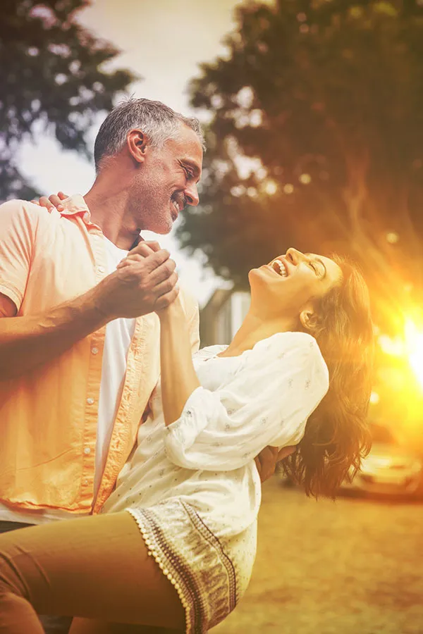 Sciatica-Treatment A couple dances outside in the sunset. Get sciatica treatment from ProCare Wellness Institute in Virginia Beach.