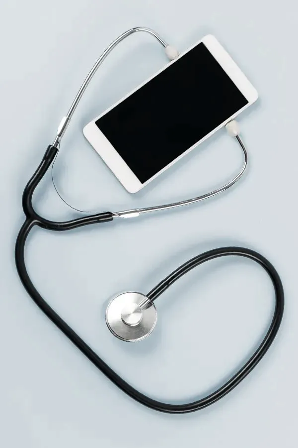 A smartphone with a stethoscope attached to it, symbolizing Telemedicine treatment from ProCare Wellness Institute in Virginia Beach.