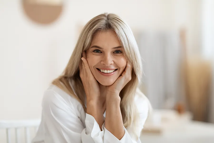 A woman smiling with clean white teeth. Get treatment for yellow teeth from ProCare Wellness Institute in Virginia Beach.